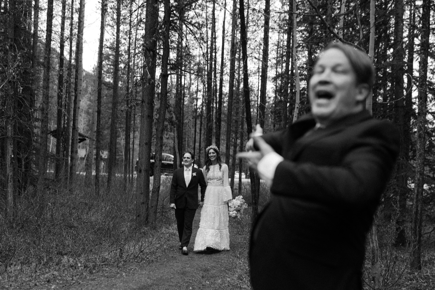 A Kananaskis Lake Elopement in the beautiful Canadian Rockies photo of outdoor reception in the forest with toasts and laughs