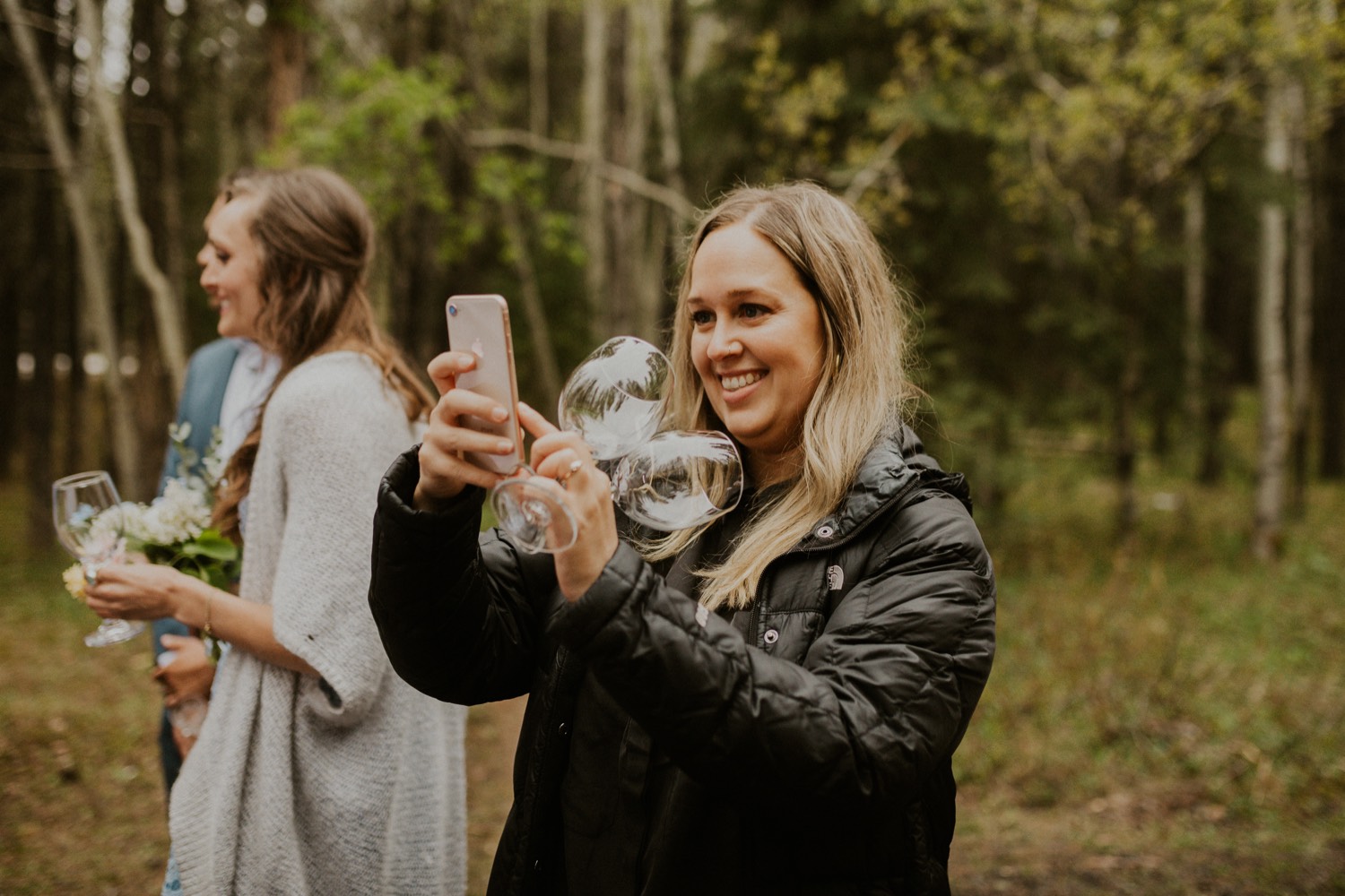 A Kananaskis Lake Elopement in the beautiful Canadian Rockies photo of outdoor reception in the forest with toasts and laughs