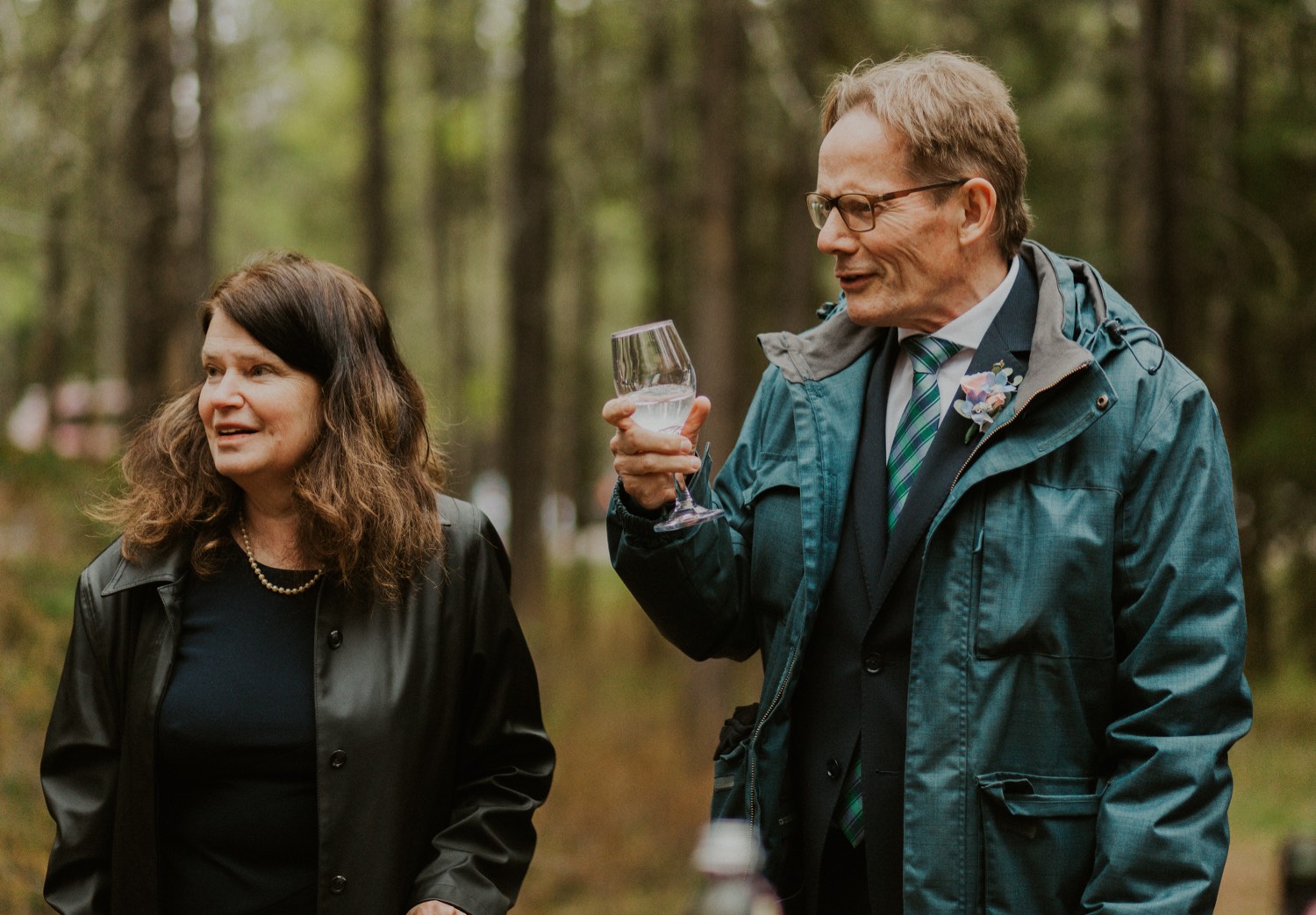 A Kananaskis Lake Elopement in the beautiful Canadian Rockies photo of outdoor reception in the forest with toasts and laughs