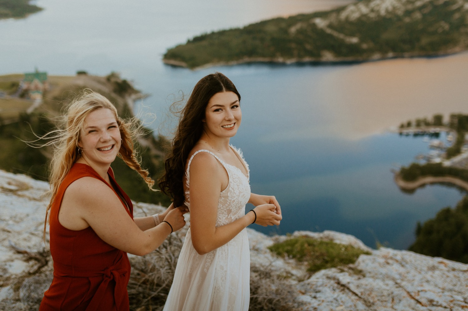 Waterton Wedding Adventurous Mountain Elopement style in the beautiful Canadian Rocky Mountains bride putting on her boho dress on a mountain top