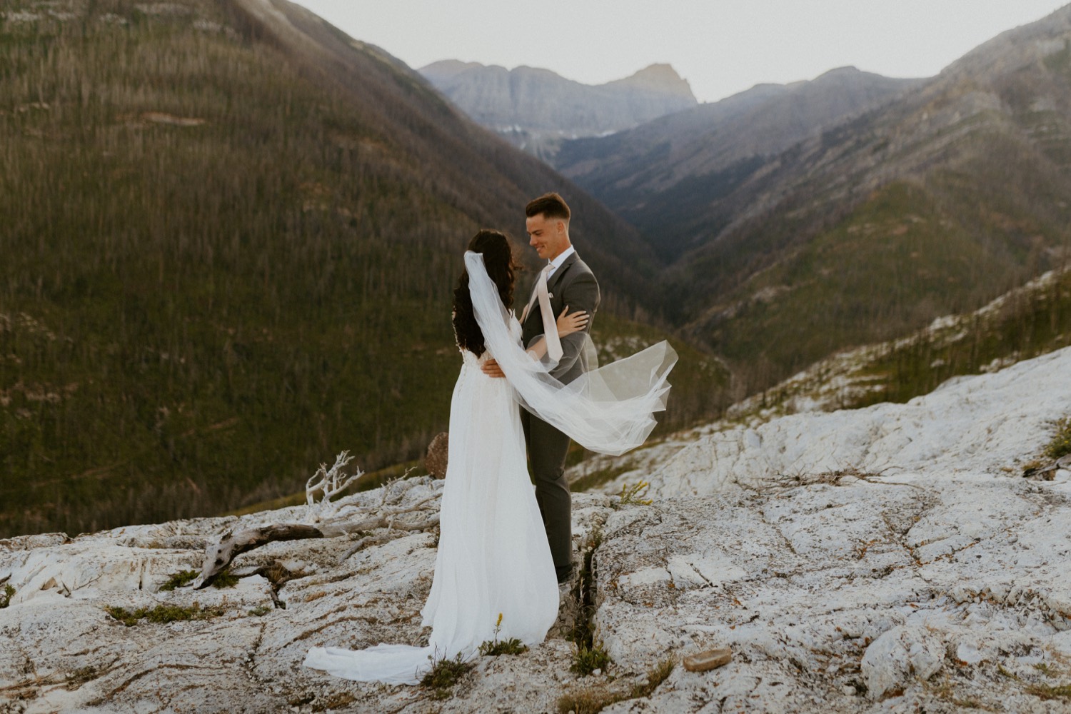 Waterton Wedding Adventurous Mountain Elopement style in the beautiful Canadian Rocky Mountains first look between bride and groom on the mountain top