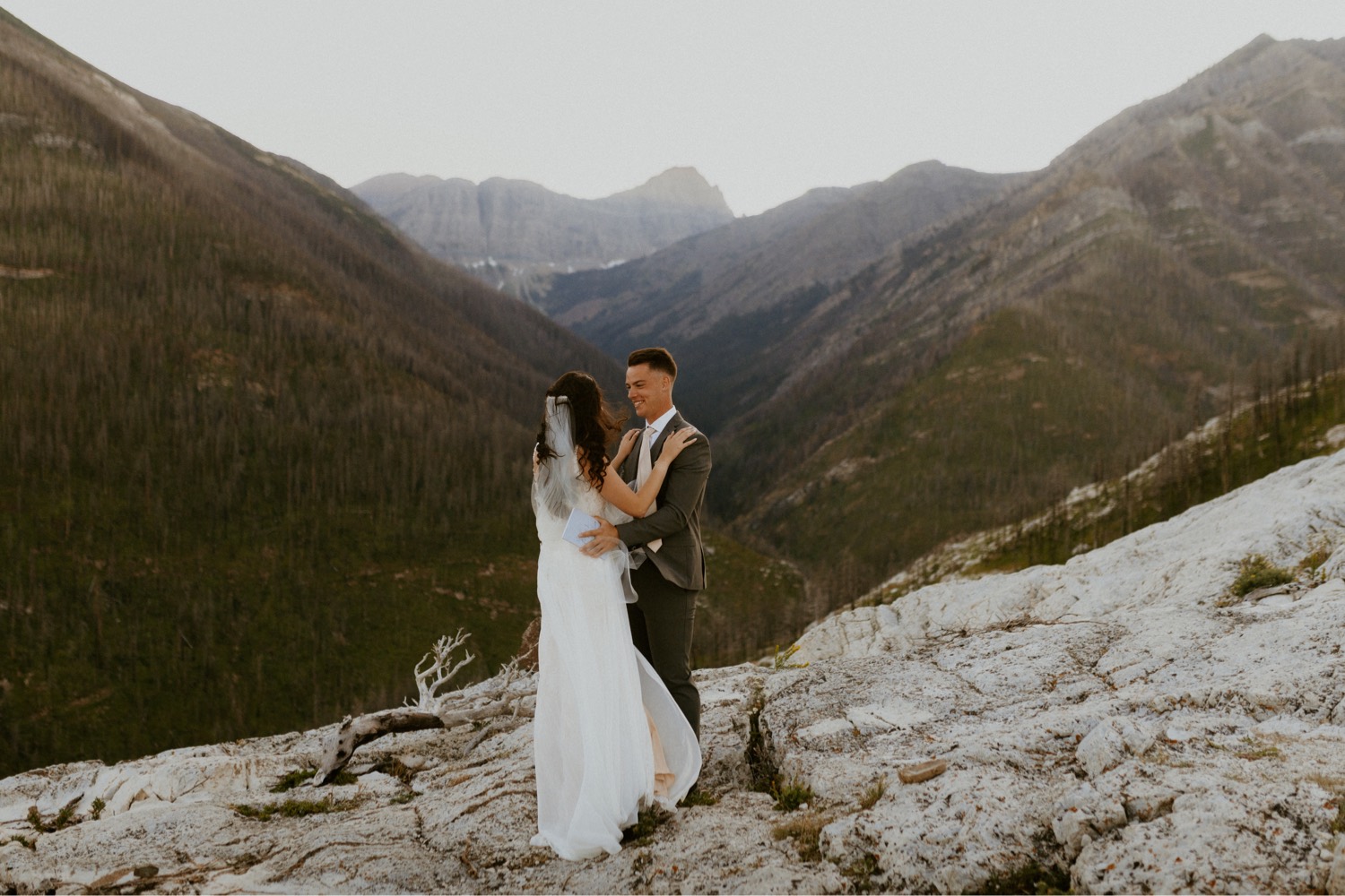 Waterton Wedding Adventurous Mountain Elopement style in the beautiful Canadian Rocky Mountains first look between bride and groom on the mountain top