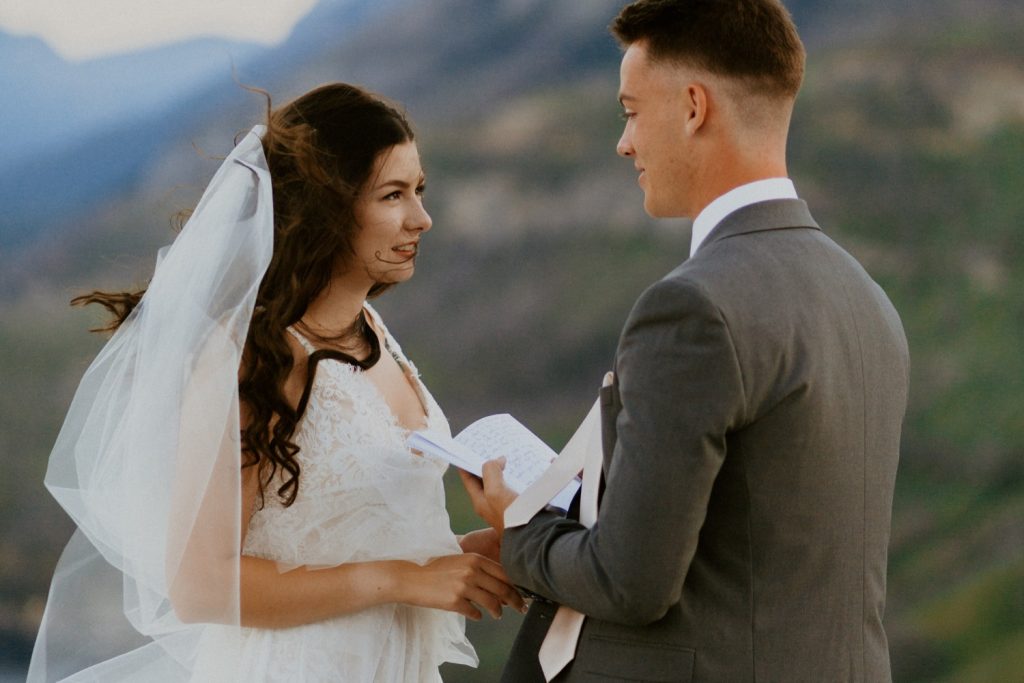 Waterton Wedding Adventurous Mountain Elopement style in the beautiful Canadian Rocky Mountains first look between bride and groom on the mountain top with personalized letters to each other