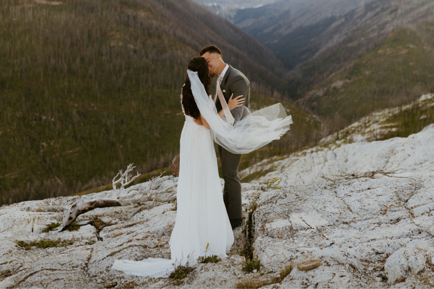 Waterton Wedding Adventurous Mountain Elopement style in the beautiful Canadian Rocky Mountains first look between bride and groom on the mountain top with personalized letters to each other