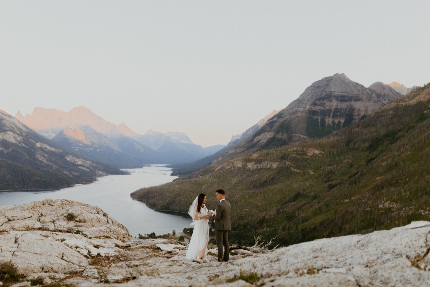 Waterton Wedding Adventurous Mountain Elopement style in the beautiful Canadian Rocky Mountains first look between bride and groom on the mountain top with personalized letters to each other