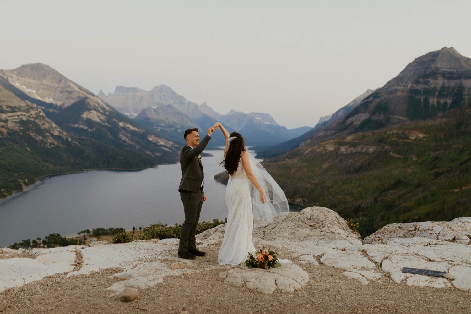 Waterton Wedding Adventurous Mountain Elopement style in the beautiful Canadian Rocky Mountains couple photos of couple on the mountain top right after their ceremony with close friends and officiant