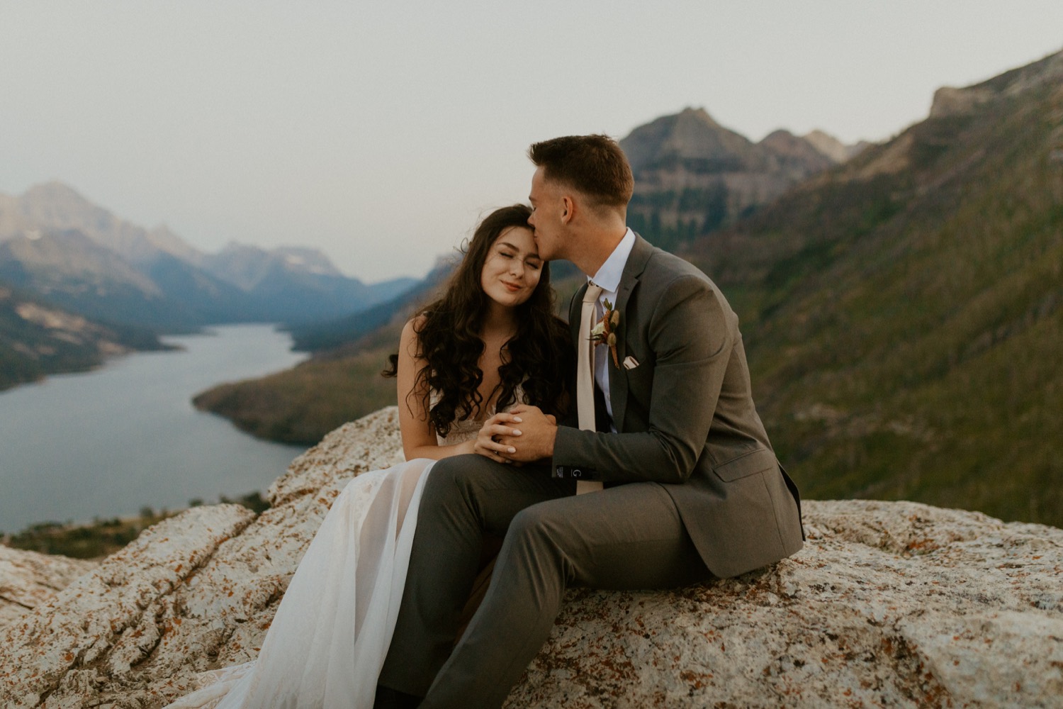 Waterton Wedding Adventurous Mountain Elopement style in the beautiful Canadian Rocky Mountains couple photos of couple on the mountain top right after their ceremony with close friends and officiant